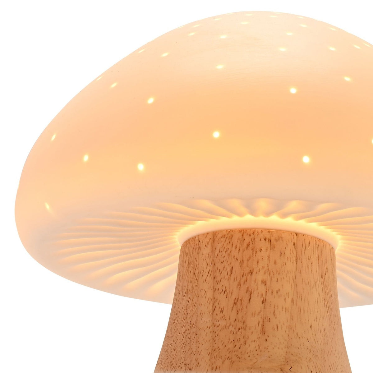 Close-up of the Pierced Mushroom Battery Powered Ceramic Table Lamp in white, showing the pierced dome cap glowing with pinprick lights above a wood-toned stem, on a plain background.