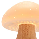 Close-up of the Pierced Mushroom Battery Powered Ceramic Table Lamp in white, showing the pierced dome cap glowing with pinprick lights above a wood-toned stem, on a plain background.