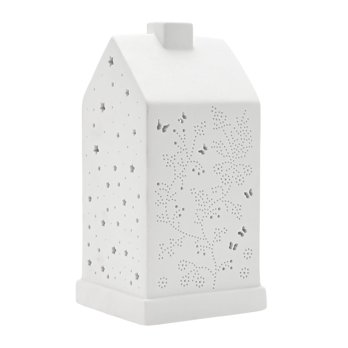 White ceramic table lamp shaped like a house with pitched roof and chimney, cut-out butterflies and floral stems on front, stars on sides, 20.5cm, plain background.