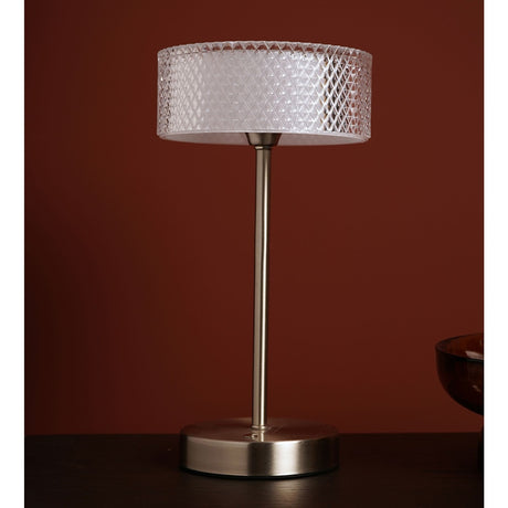 Nickel USB touch table lamp with a crystal-effect diamond-cut drum shade on a slim silver stem and round base, shown on a dark table against a dark red wall.