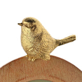 Close-up of the Wood Effect Oval Resin Photo Frame in brown, showing a detailed gold-tone bird perched on the frame's textured, wood-effect edge against a plain white background.