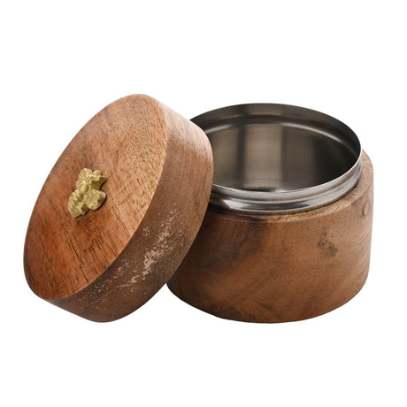 Round acacia wood salt box storage jar with stainless steel liner and gold-coloured bee lid detail, lid resting open beside the base on a plain background.