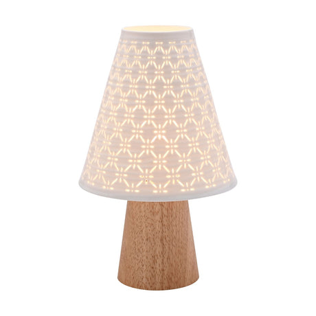Pierced Cone Ceramic Table Lamp with Wooden Base in white, featuring a tapered wood base and a ribbed, pierced ceramic shade glowing warmly, shown lit on a plain white background.
