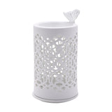 Round white ceramic wax melt burner with cut-out lattice pattern body and a small butterfly perched on the rim, shown on a plain white background.