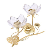 Two-stem flower glass candle holder with clear glass petals on gold stems, gold tealight cups, pierced leaves and small blossoms at the base, on a white background.
