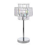 Glass table lamp with a tiered crystal effect shade in clear glass prisms, set on a slim chrome stem and round chrome base, shown on a plain white background.
