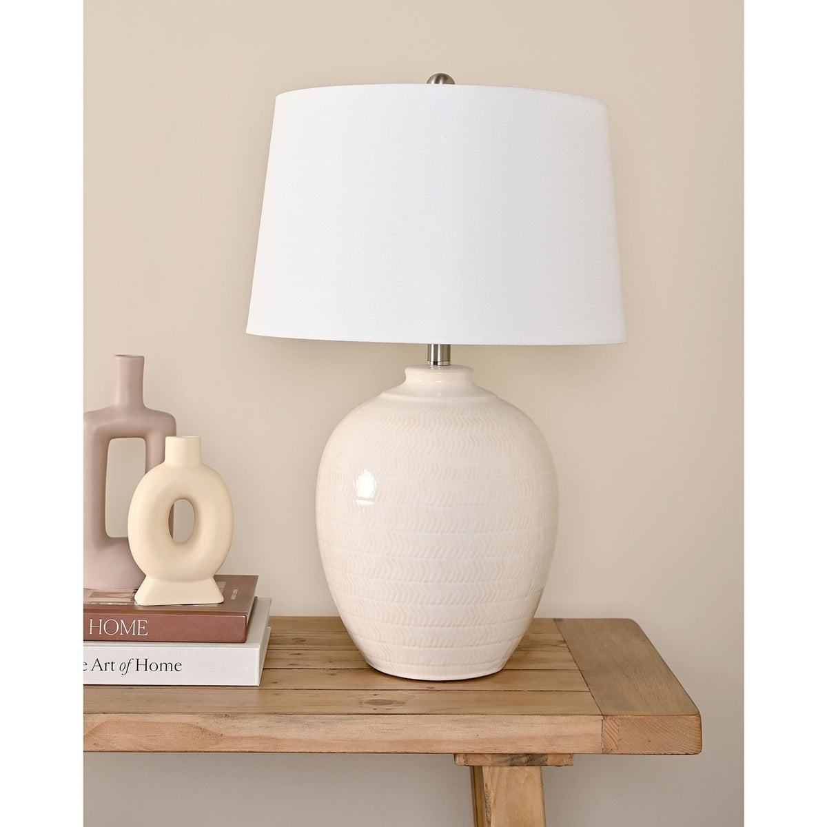 Chevron Ceramic Table Lamp with Tapered Shade 60.5cm in White, with a rounded textured base and white fabric shade, styled on a wooden console table beside decorative vases and books.