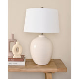 Chevron Ceramic Table Lamp with Tapered Shade 60.5cm in White, with a rounded textured base and white fabric shade, styled on a wooden console table beside decorative vases and books.