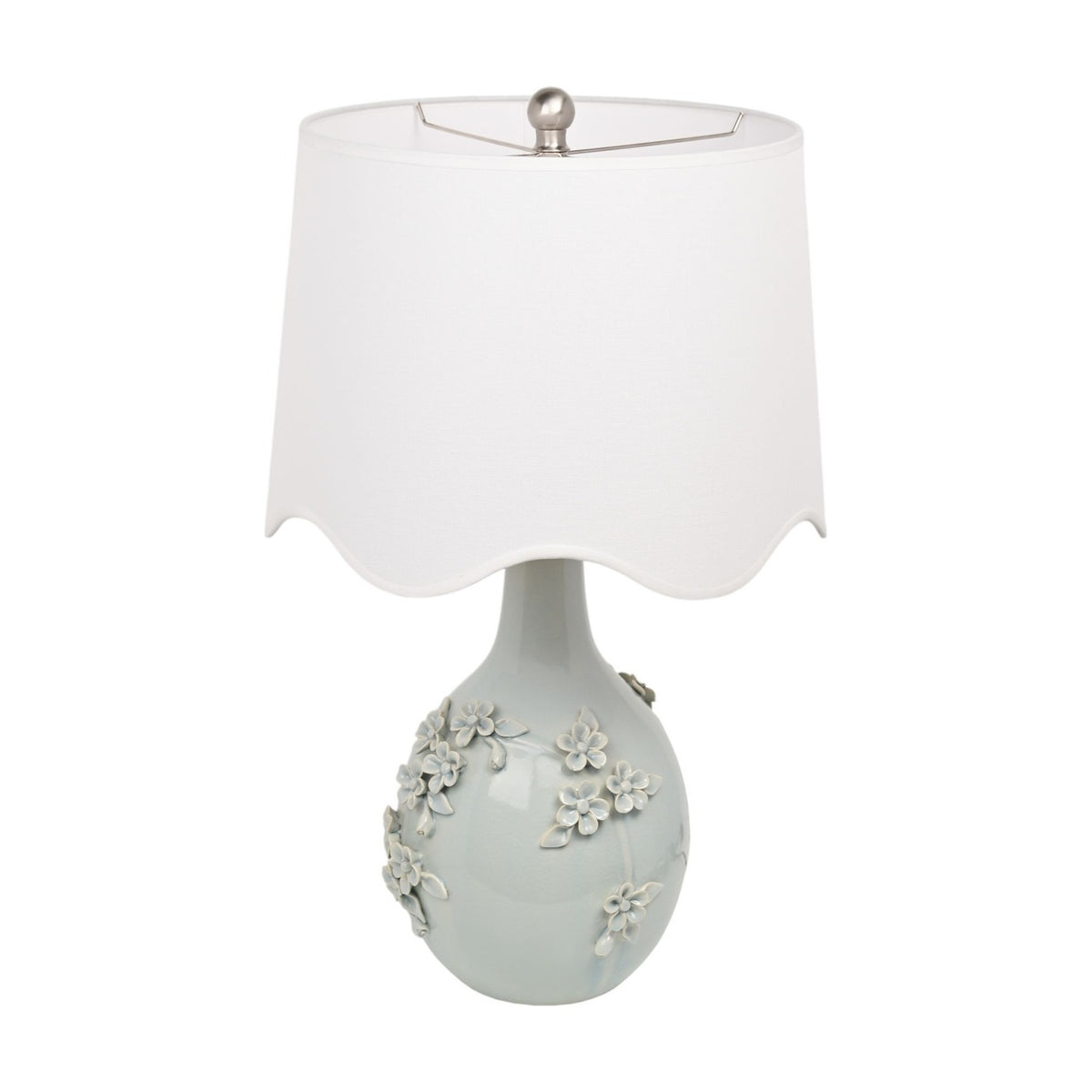 Floral Ceramic Table Lamp 64cm in pale blue with raised ceramic blossom detail on a rounded base, topped with a white scalloped drum shade, shown on a plain white background.