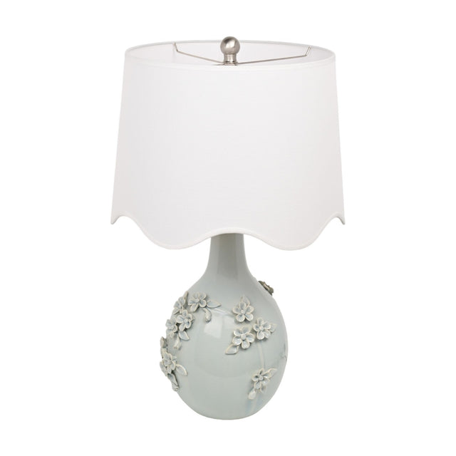 Floral Ceramic Table Lamp 64cm in pale blue with raised ceramic blossom detail on a rounded base, topped with a white scalloped drum shade, shown on a plain white background.