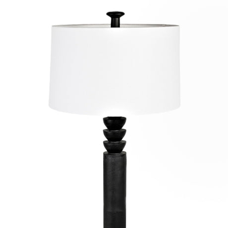 Zennamor floor lamp with white drum shade and black resin column featuring stacked ring detail beneath the shade, shown on a plain white background.