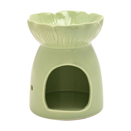 Green ceramic flower wax melt burner with scalloped blossom-shaped dish, ridged petal detail, and an arched tealight opening at the base, shown on a white background.