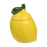 Lemon-shaped earthenware sugar storage jar in yellow with dimpled peel texture and a glossy green leaf-topped lid, shown on a plain white background.