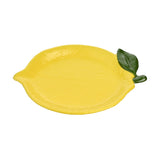 Textured lemon-shaped earthenware plate in yellow with dimpled peel-like surface, raised rim, and a sculpted green leaf accent, shown on a plain white background.