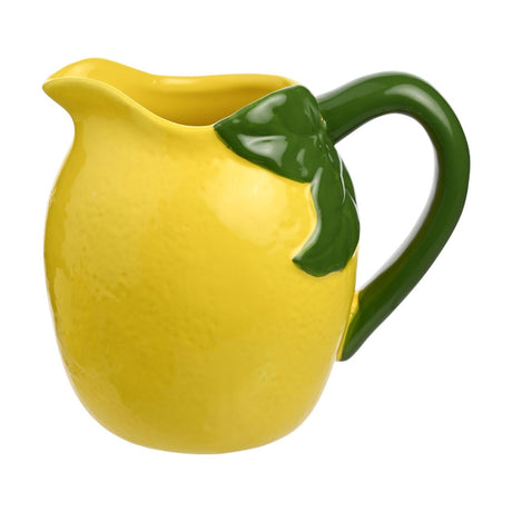 Small lemon-shaped earthenware jug in glossy yellow with a dimpled peel texture, curved green handle, raised green leaf accent, and wide pouring lip, shown on a plain white background.