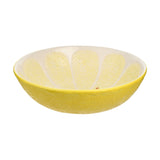 Round earthenware serving bowl designed as a lemon slice, with textured yellow peel-effect exterior and pale segmented interior divided by white lines, shown on a plain white background.