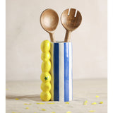 Lemon Ceramic Vase with Stripes 21cm in Blue, a cylindrical vase with blue and white stripes and moulded yellow lemons, holding two wooden serving spoons on a plain background.