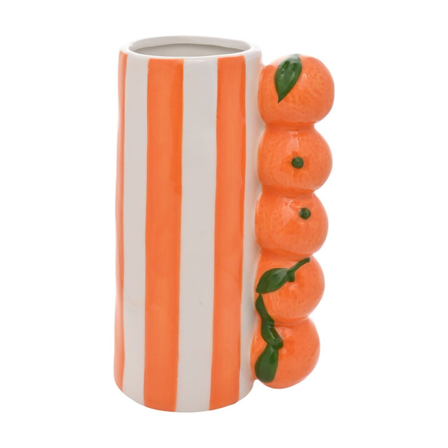 Ceramic vase with bold orange and white vertical stripes, featuring a stacked column of five glazed citrus fruits with green leaves on one side, shown on a plain white background.