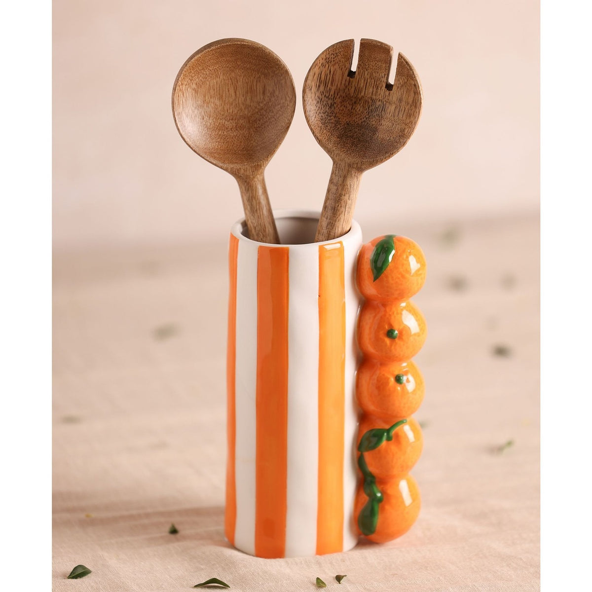 Striped orange and white ceramic vase, 21cm, with a column of stacked citrus fruit detail, holding two wooden salad servers against a neutral background.