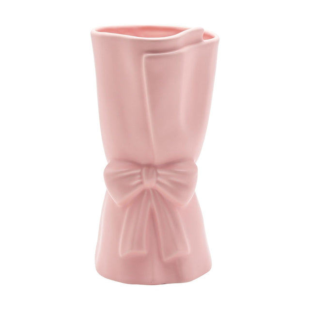 Pink ceramic vase styled as a wrapped bouquet with a folded edge and a ribbon bow at the centre, matt finish, 24cm tall, on a plain white background.