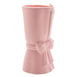 Pink ceramic vase shaped like a wrapped bouquet, 24cm tall, with a folded rim edge and a tied ribbon bow with trailing tails, matt finish, on a plain white background.