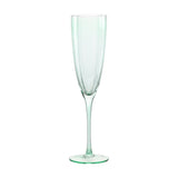 Green scallop stemmed glass champagne flute with panelled bowl, scalloped rim, slim stem and round flat foot, shown on a plain white background.