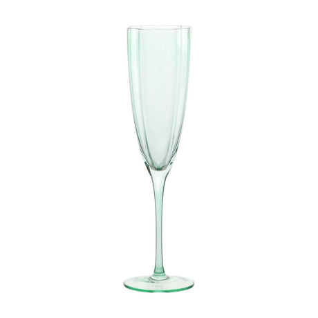 Green scallop stemmed glass champagne flute with panelled bowl, scalloped rim, slim stem and round flat foot, shown on a plain white background.