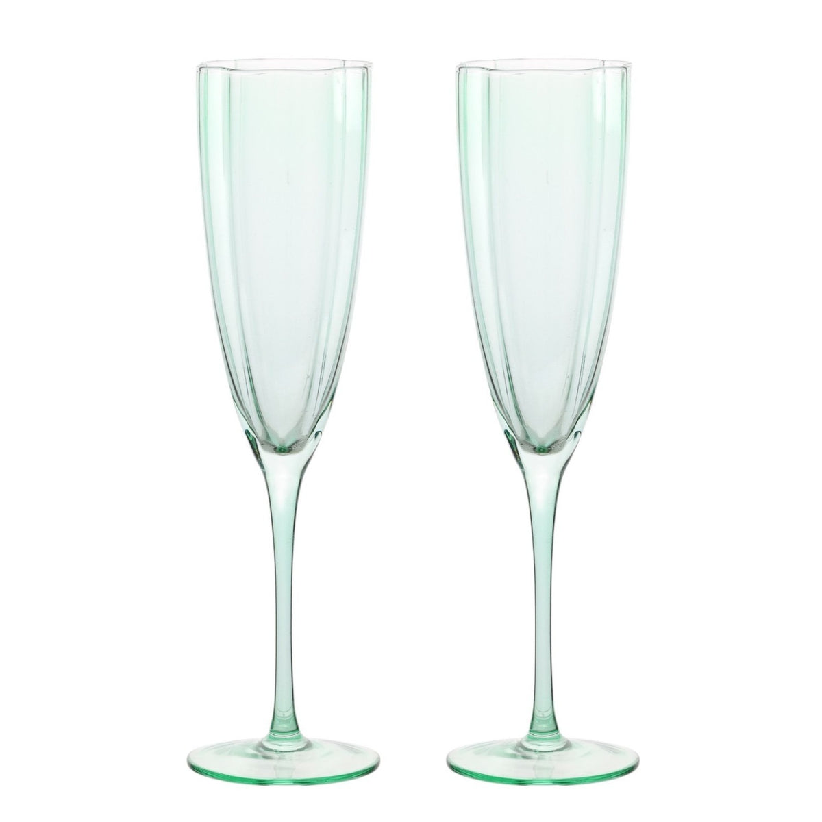 Set of two scallop stemmed champagne flutes in pale green glass with panelled bowls, slim stems and round flat feet, shown against a plain white background.