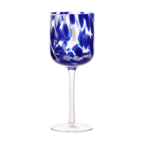 Wine glass with a tall clear bowl scattered in cobalt blue and white tortoise shell spots, set on a slim clear stem and flat foot, shown on a plain white background.