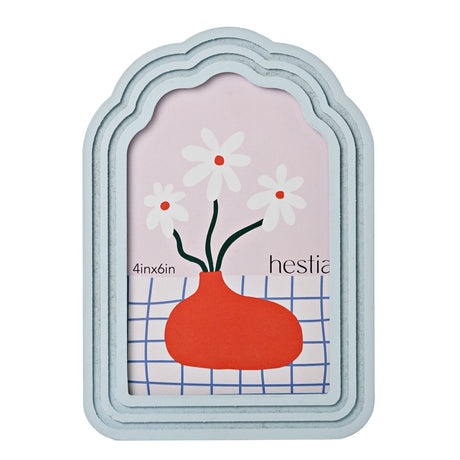 Scalloped arched wooden photo frame in pale blue with stepped tiered border, holding a 6 x 4in portrait photo, shown on a plain white background.