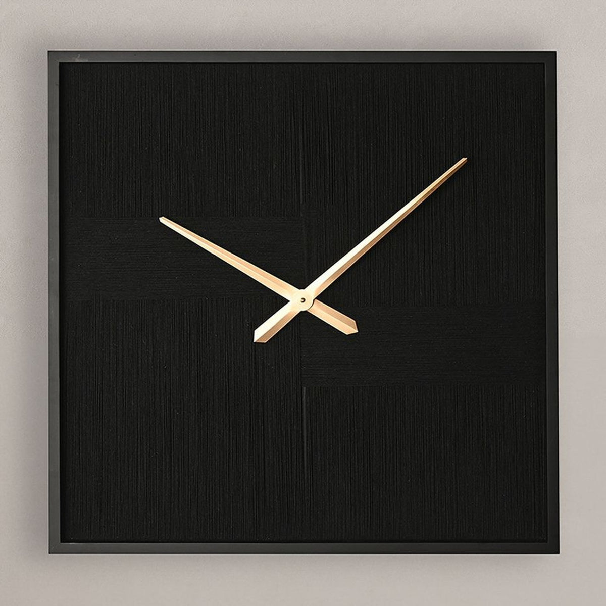 Square wall clock with black woven thread face, slim black frame, and slender gold hands, shown against a plain light grey background.
