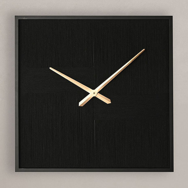 Square wall clock with black woven thread face, slim black frame, and slender gold hands, shown against a plain light grey background.
