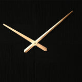 Close-up of the Square Woven Thread Face Wall Clock in black, showing slender gold hands against a numberless textured black dial with panelled thread directions.