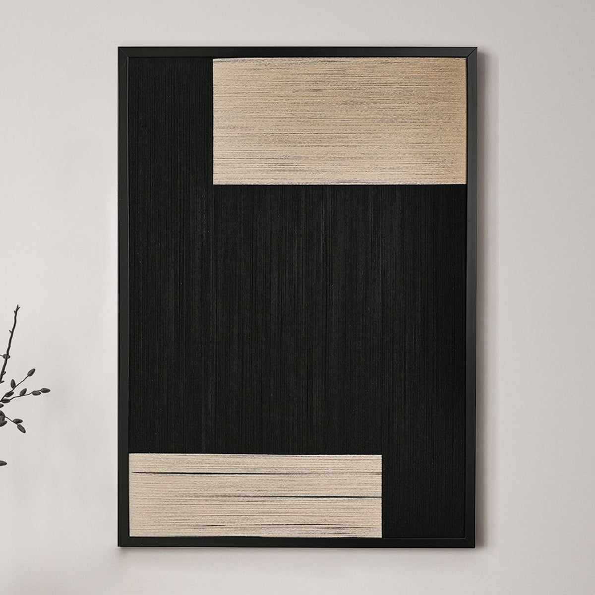Framed Woven Thread Wall Art, 50cm x 70cm, with vertical black threads and two crosswise cream blocks, black frame, hung on a plain light wall.