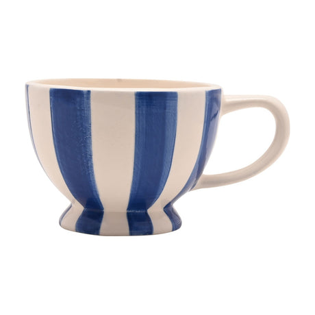 Round footed earthenware mug with broad blue and white brushed stripes, curved white handle, and a short pedestal base, shown on a plain white background.