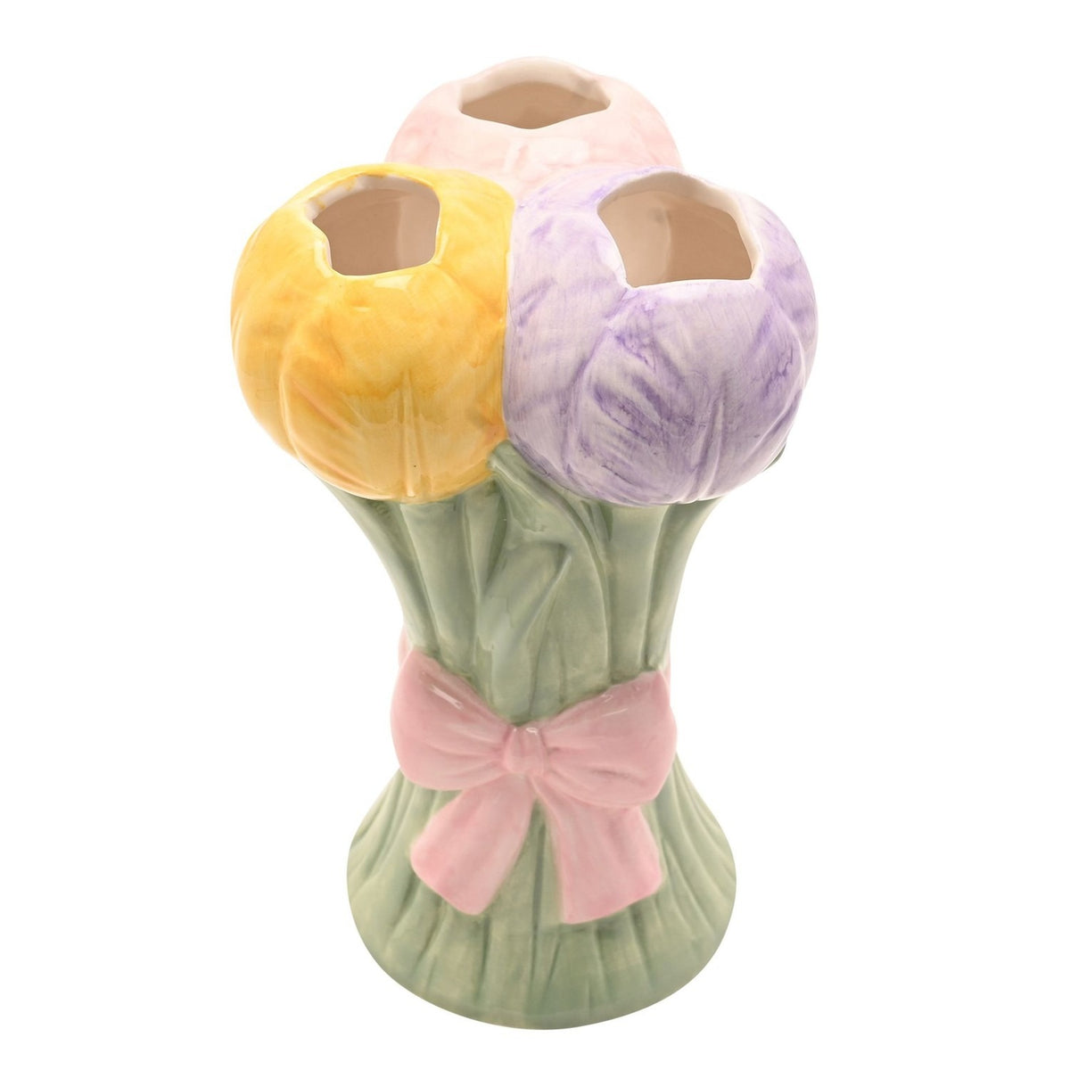 Ceramic vase shaped as three tulip blooms in yellow, lilac, and pink on sage green stems with a raised pink bow, set against a plain white background.