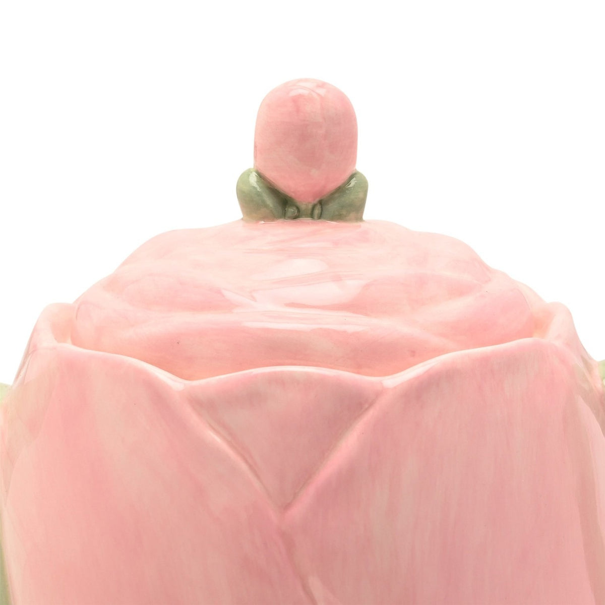Close-up of the Blush Tulip earthenware teapot lid in pink, showing petal-shaped moulding and a rounded bud knob held by sage green leaves, on a white background.