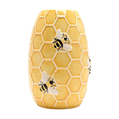 Oval ceramic vase shaped like a bee hive, with a yellow speckled finish, raised cream honeycomb pattern, and black and white bee details, shown against a plain white background.