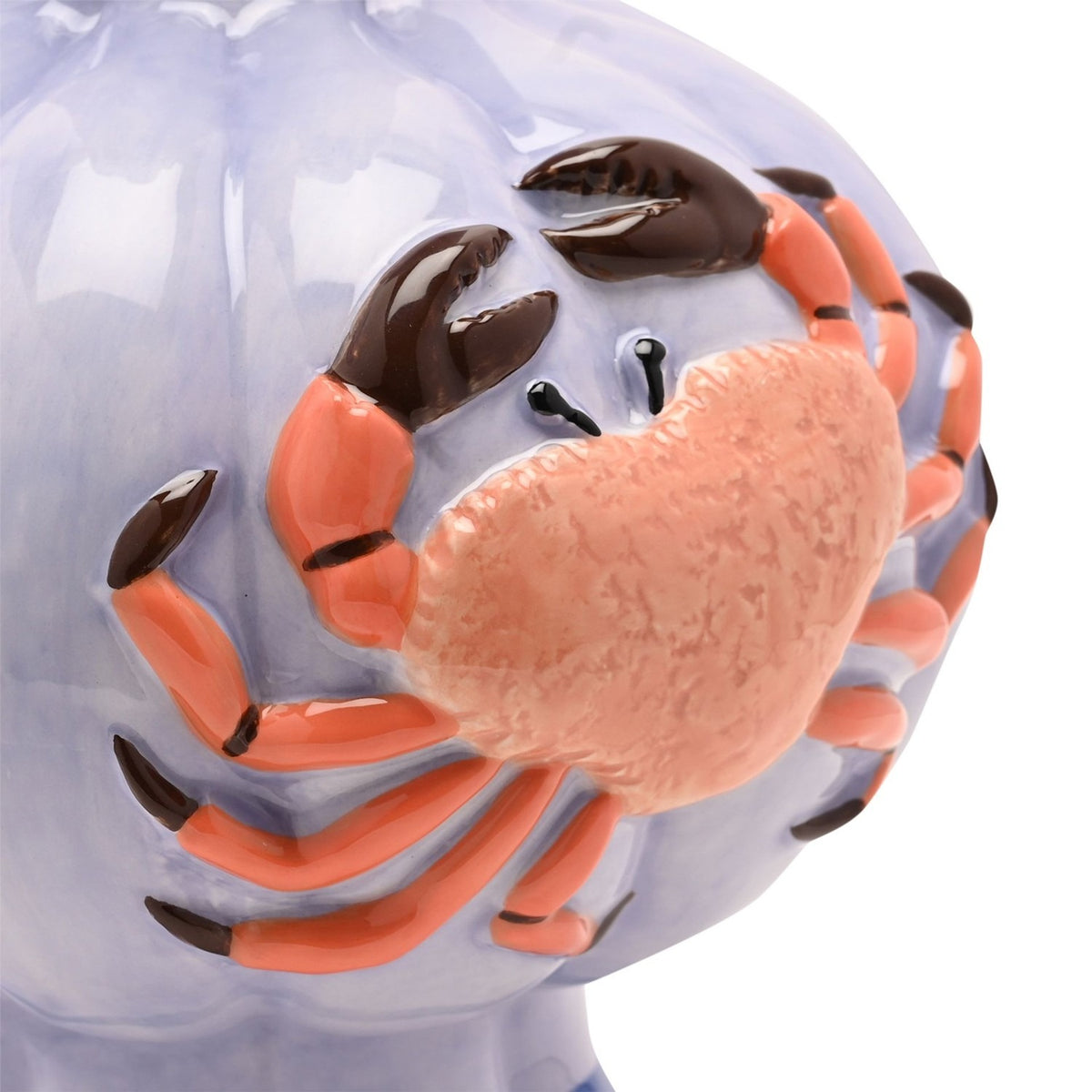 Close-up of a hand-painted ceramic vase in periwinkle blue with a raised, textured orange crab design featuring dark brown-tipped claws, against a plain white background.