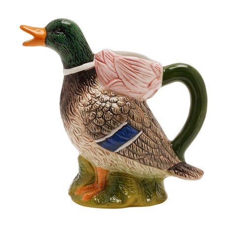 Dolomite ceramic jug shaped as a mallard duck on a grassy base, with a glossy green head, orange bill and feet, speckled brown feathers, blue wing detail, and a green handle, on a white background.