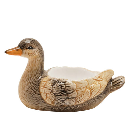 Mallard Earthenware Egg Cup in brown, shaped as a sitting duck with textured feather detail, raised beige wings, orange beak, and a white egg cup set into its back, on a plain white background.
