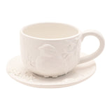 White earthenware teacup and saucer, 400ml, with a raised bird and foliage design moulded in relief on the cup, plain white background.