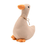 Duck-shaped door stop in light brown woven-look fabric with an upright neck, rounded body, orange beak and webbed feet, and a jute cord bow at the neck, on a plain white background.