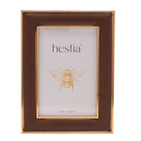 Freestanding rectangular photo frame in brown textured plastic with gold-coloured edge trim, holding a 4x6in sample print on a plain white background.