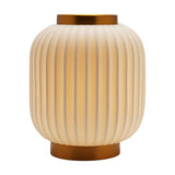 Small ribbed lantern-style porcelain table lamp in white with gold bands at crown and base, rounded ribbed shade, shown lit on a plain white background.