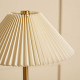 Close-up of the Pleated Shade USB LED Touch Table Lamp, showing cream fine pleats and a brushed bronze stem against a plain light background.