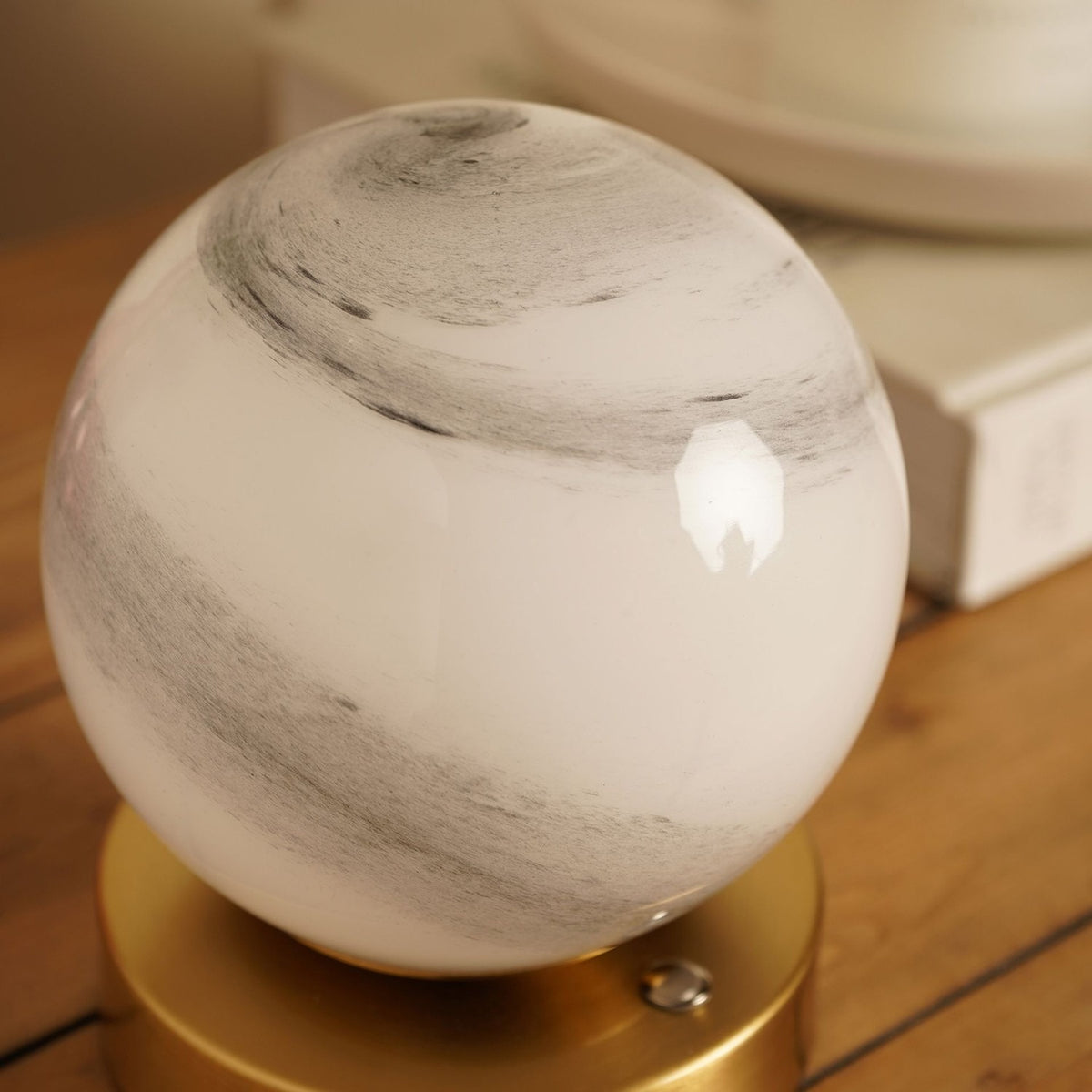 Marbled Glass Ball USB LED Touch Table Lamp with round white glass globe swirled in grey marbling, set on a low brushed brass-toned base.