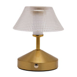 Small table lamp with a clear diamond-etched glass shade on a brushed bronze-toned base, featuring a touch control and round stud detail, shown on a plain white background.