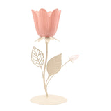 Floral single candle holder with a pink tulip-shaped cup on a cream metal stem, featuring two leaves and a small bud, set on a round base against a plain white background.