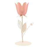 Floral single candle holder with a pink tulip-shaped cup on a cream metal stem, featuring two leaves and a small bud, set on a round base against a plain white background.